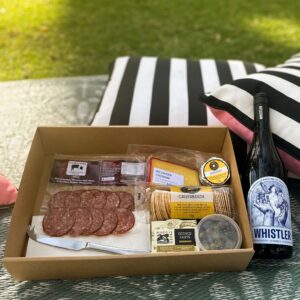 Picnic and bottle of wine on Whistler Wines'Cellar Door lawn.